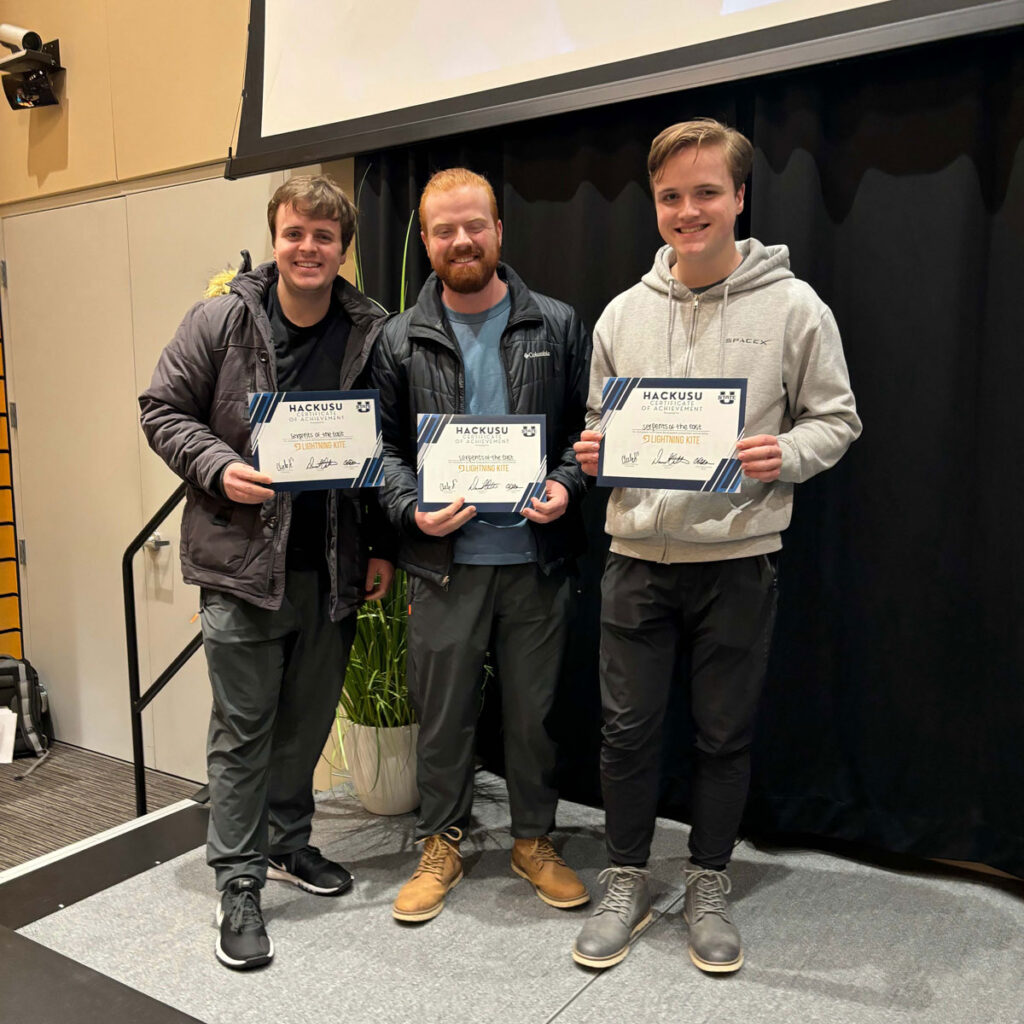 Three USU ASPIRE students receiving certificates for winning in their category at HackUSU.