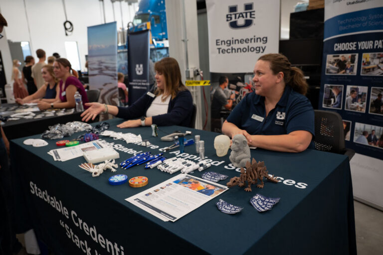 Representatives from Utah State University's Engineering School host a table at the ASPIRE Open House.
