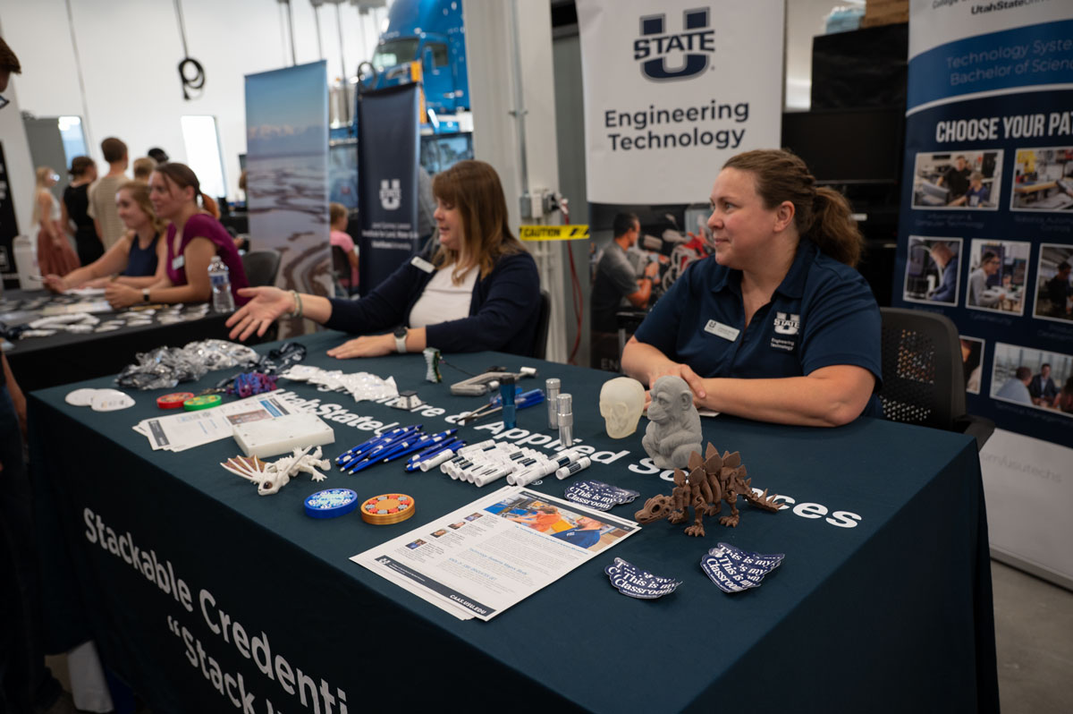 Representatives from Utah State University's Engineering School host a table at the ASPIRE Open House.