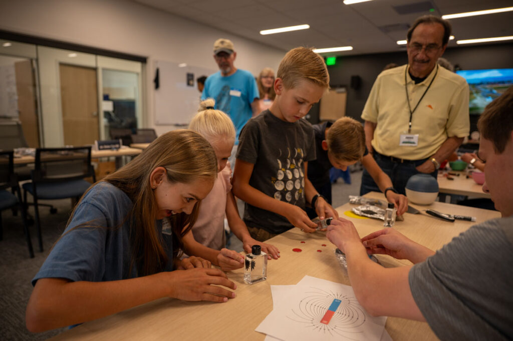 Children learn the exciting scientific principles surrounding magnetism, with help from an ASPIRE engineering student.