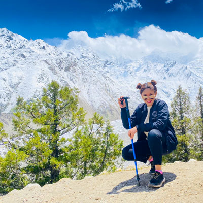 Zainab poses in front of the mountaing on a trek of Nanga Parbat (or "Naked Mountain") in the Western Himalayas, the second most prominent peak in the range after Mt. Everest and the 9th tallest in the world. 